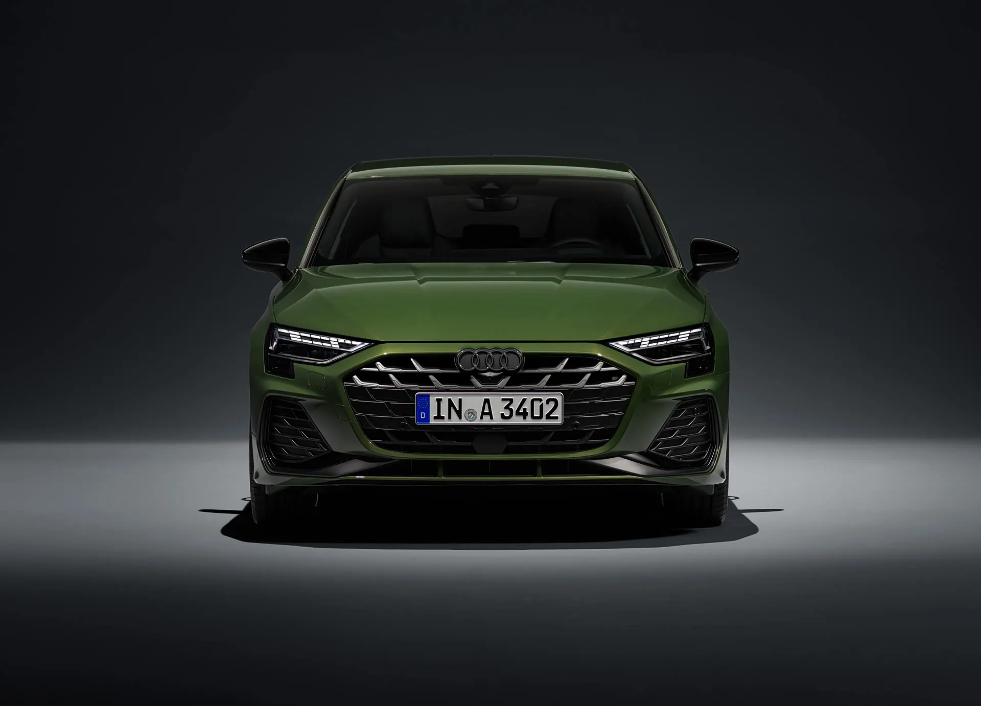 Audi A3 Sportback in green, front view in a studio